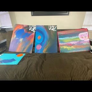 4 UGLY Paintings sitting on a wall